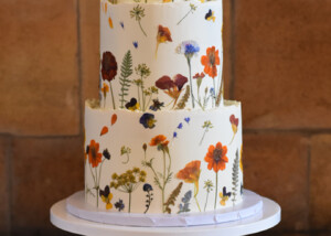 claire and josh autumn themed pressed flower wedding cake at buxted park hotel