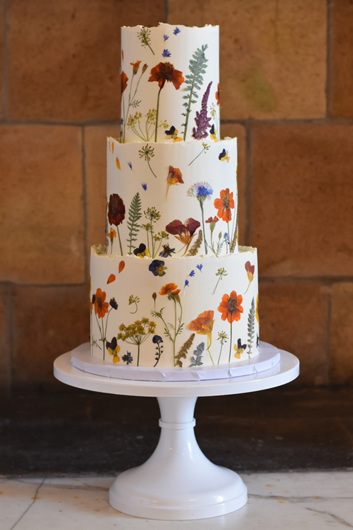 claire and josh autumn themed pressed flower wedding cake at buxted park hotel